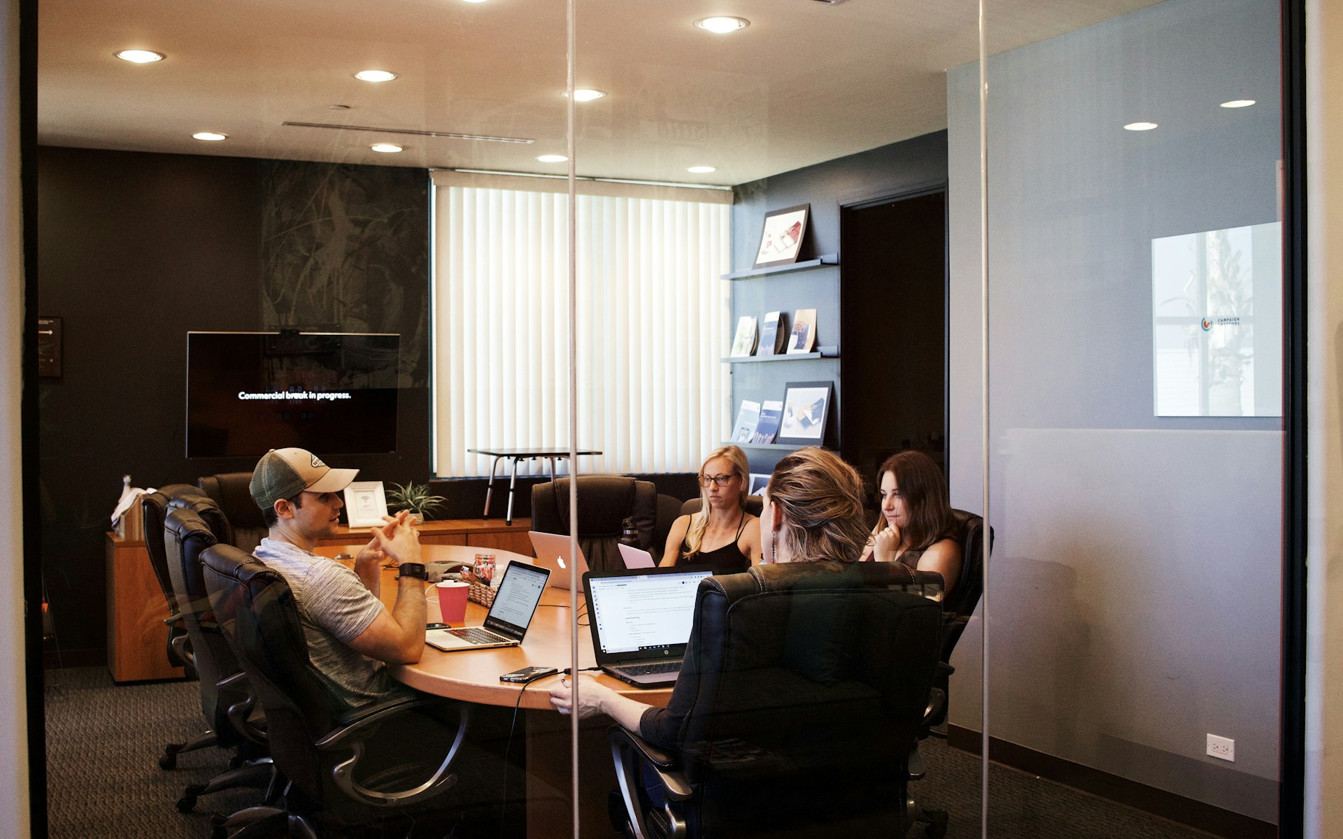 people sitting near table with laptop computer