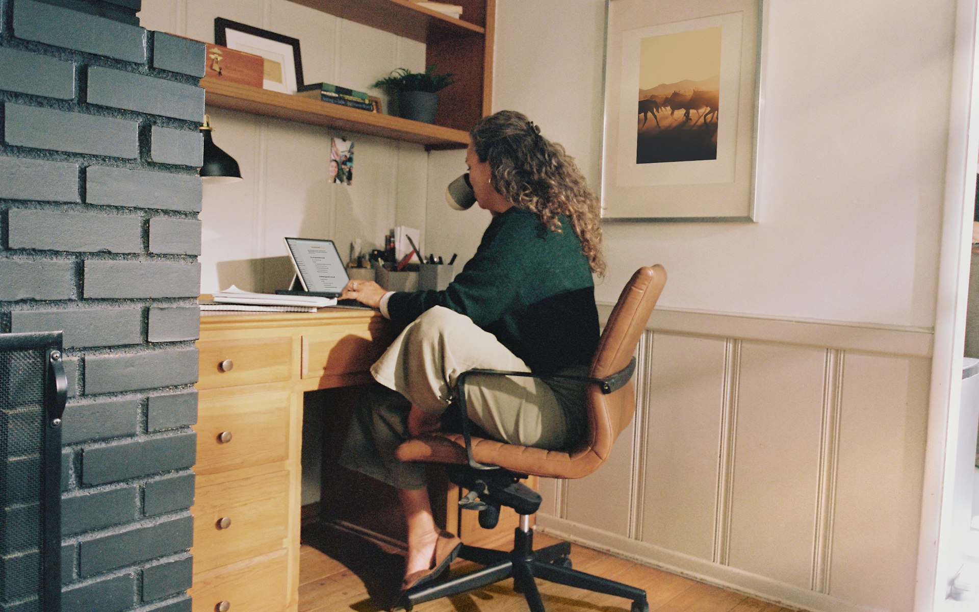 Woman working at desk with coffee